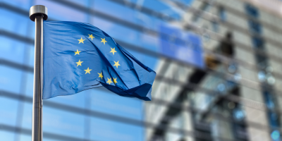 EU-lippu liehuu tangossa lasiseinän edustalla.